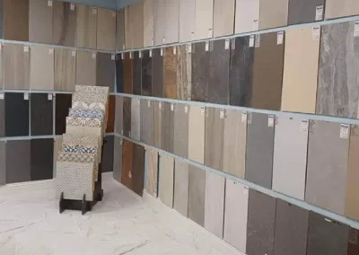 Assortment of large tile samples displayed on racks in a flooring showroom