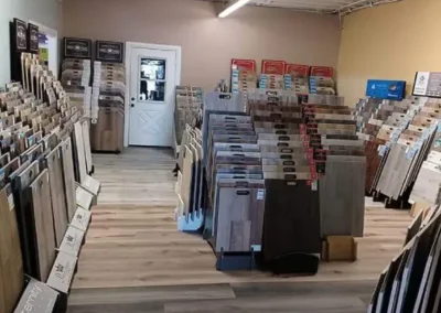 Interior of a flooring store with various samples of laminate and vinyl plank flooring on display